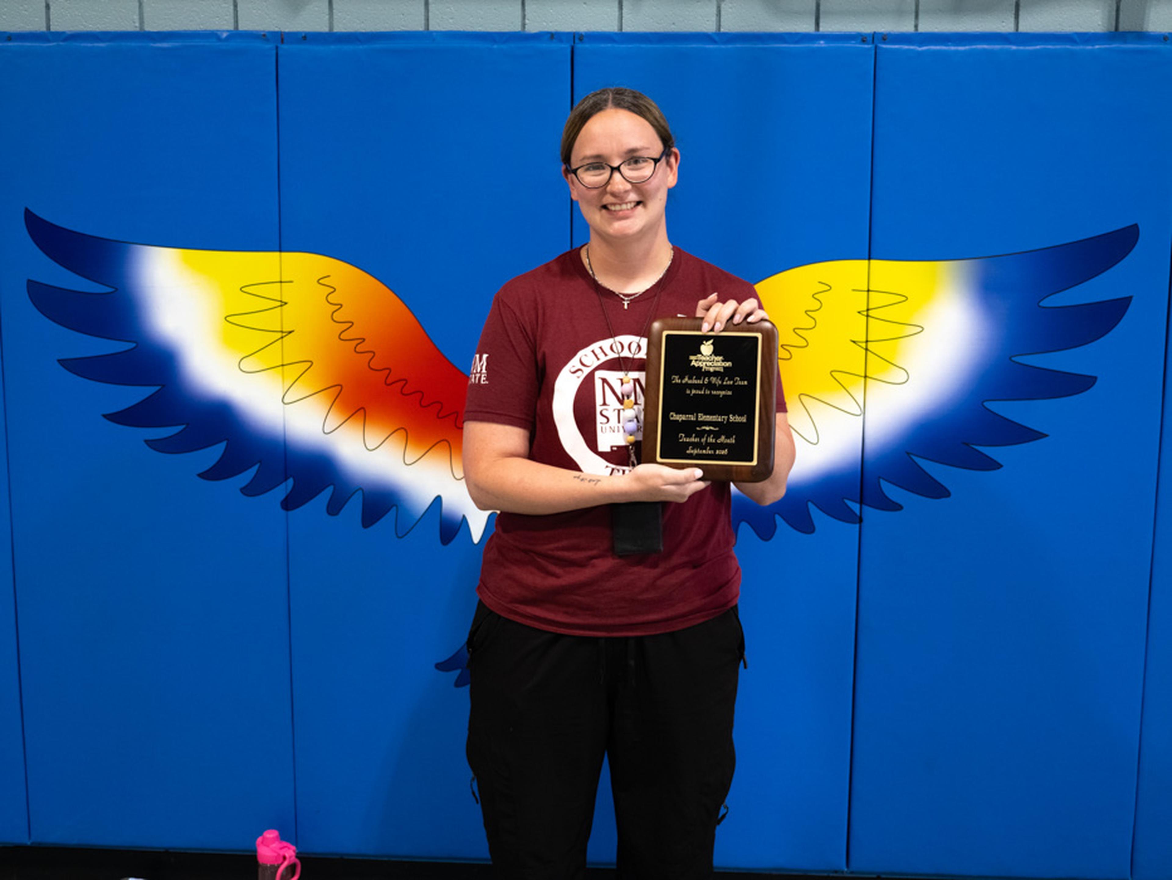 Ms. Quintana proudly displays her Teacher Appreciation plaque, celebrating the positive impact she makes on Chaparral Elementary School students each day.