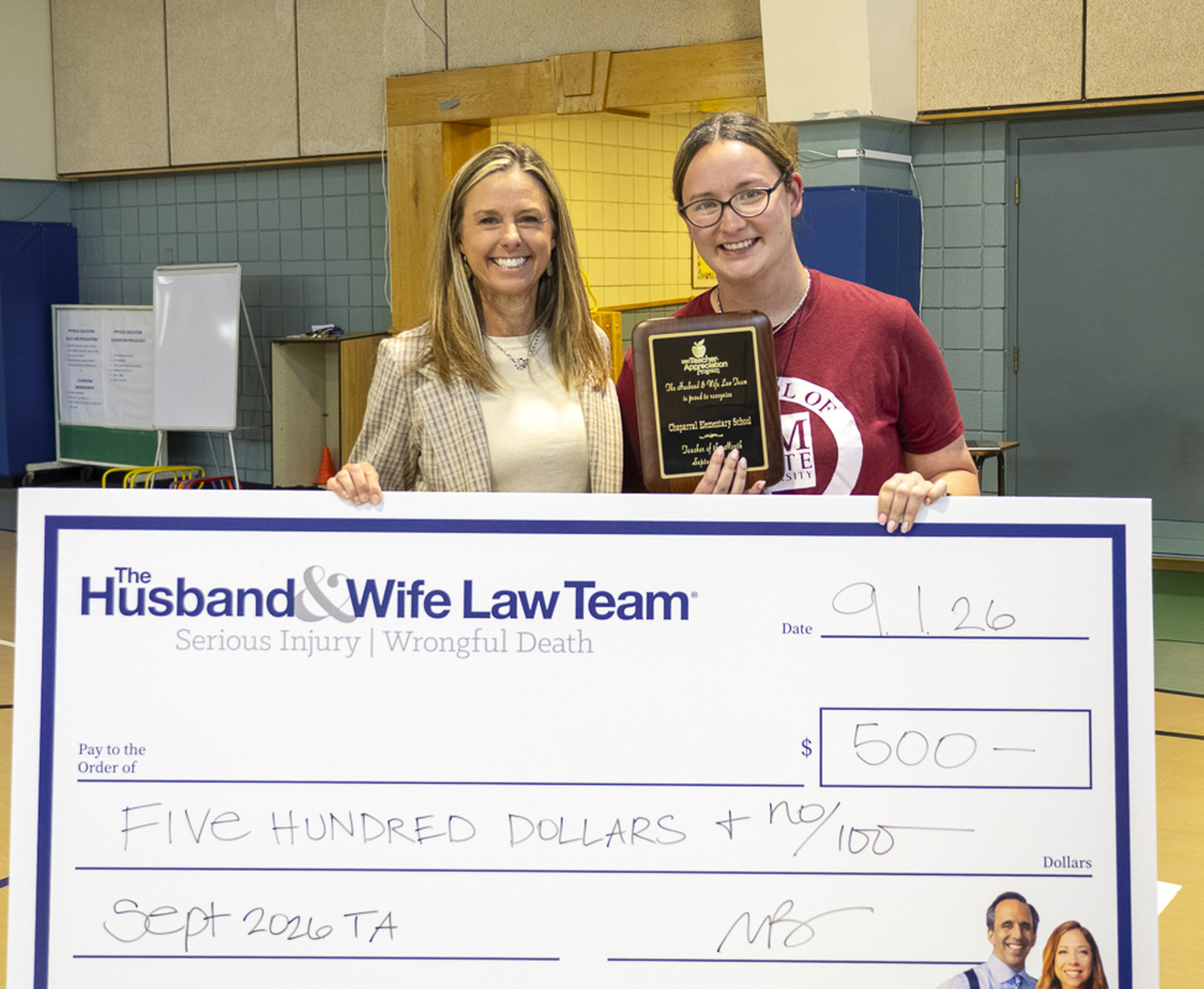 Ms. Quintana proudly displays her Teacher Appreciation plaque and $500 award from the Husband & Wife Law Team, recognizing her outstanding dedication to students at Chaparral Elementary School.