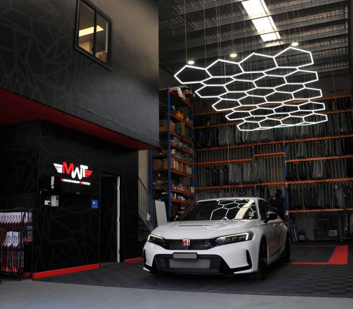 MWT technician with a customer beside a car at the Warwick Farm workshop