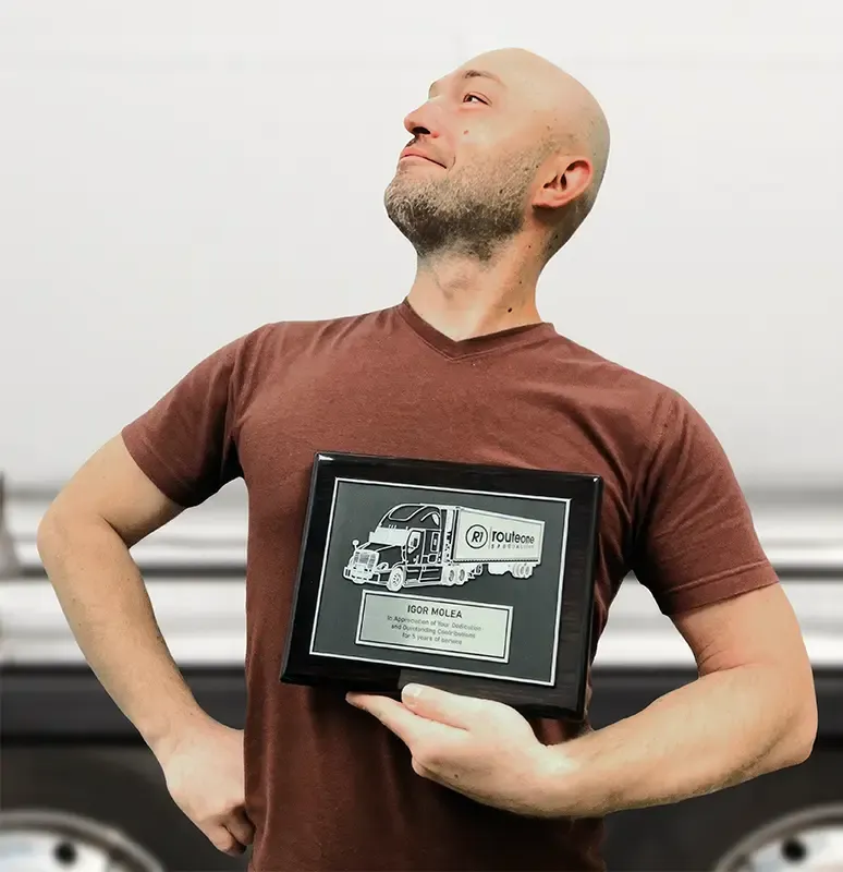 RouteOneTransport employee with an award
