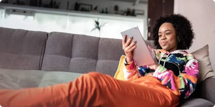 Woman on couch with tablet