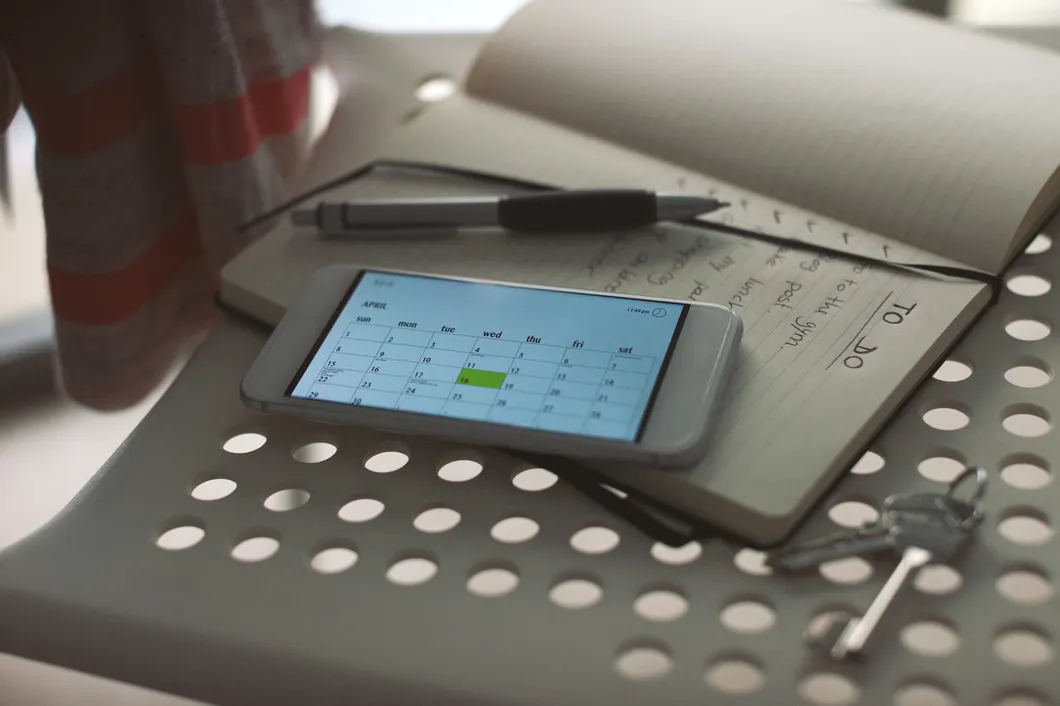 Phone and notepad on a chair