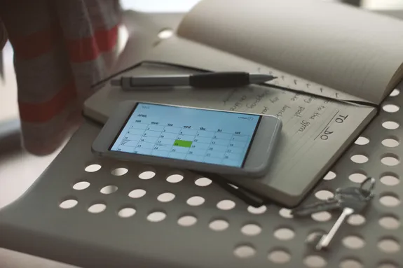 Phone and notepad on a chair