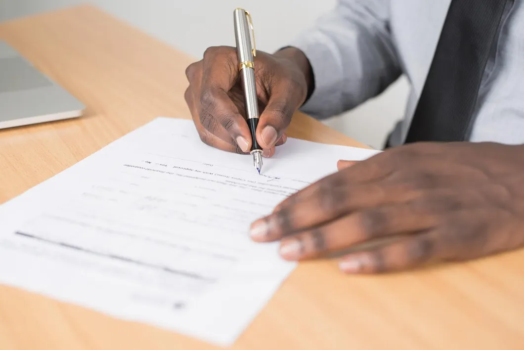 Man signing documents with pen