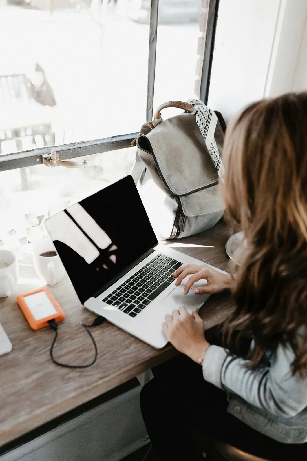 Woman using a laptop in a cafe