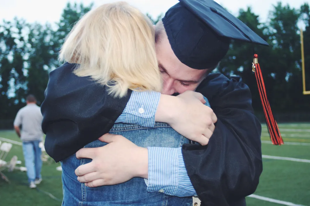 man-hugging-person-after-graduation