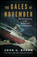 Book cover: an ore freighter listing amid towering waves and dark storm clouds; title "The Gales of November," author John U. Bacon