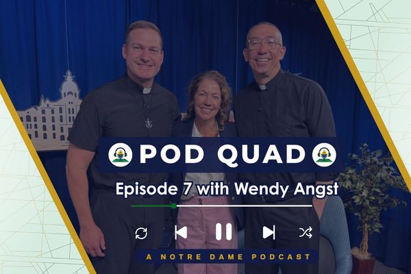 Three smiling individuals stand in front of a blue curtain with "Pod Quad" and "Episode 7 with Wendy Angst" text overlay.