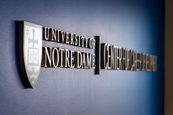 Close up shot of the University of Notre Dame Career Development logo in metal on a navy wall