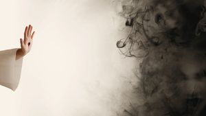 Man pushing away Satan represented by black smoke