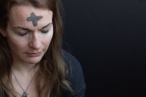 Image of woman with ash in shape of cross on head