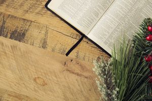 Image of a Bible with fresh garlands representing Christmas
