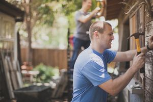 Man hammering representing service