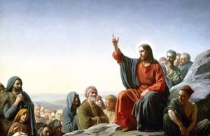 Sermon on the Mount by Carl Bloch (1877), depicting Jesus seated on a rock, preaching to a surrounding crowd.