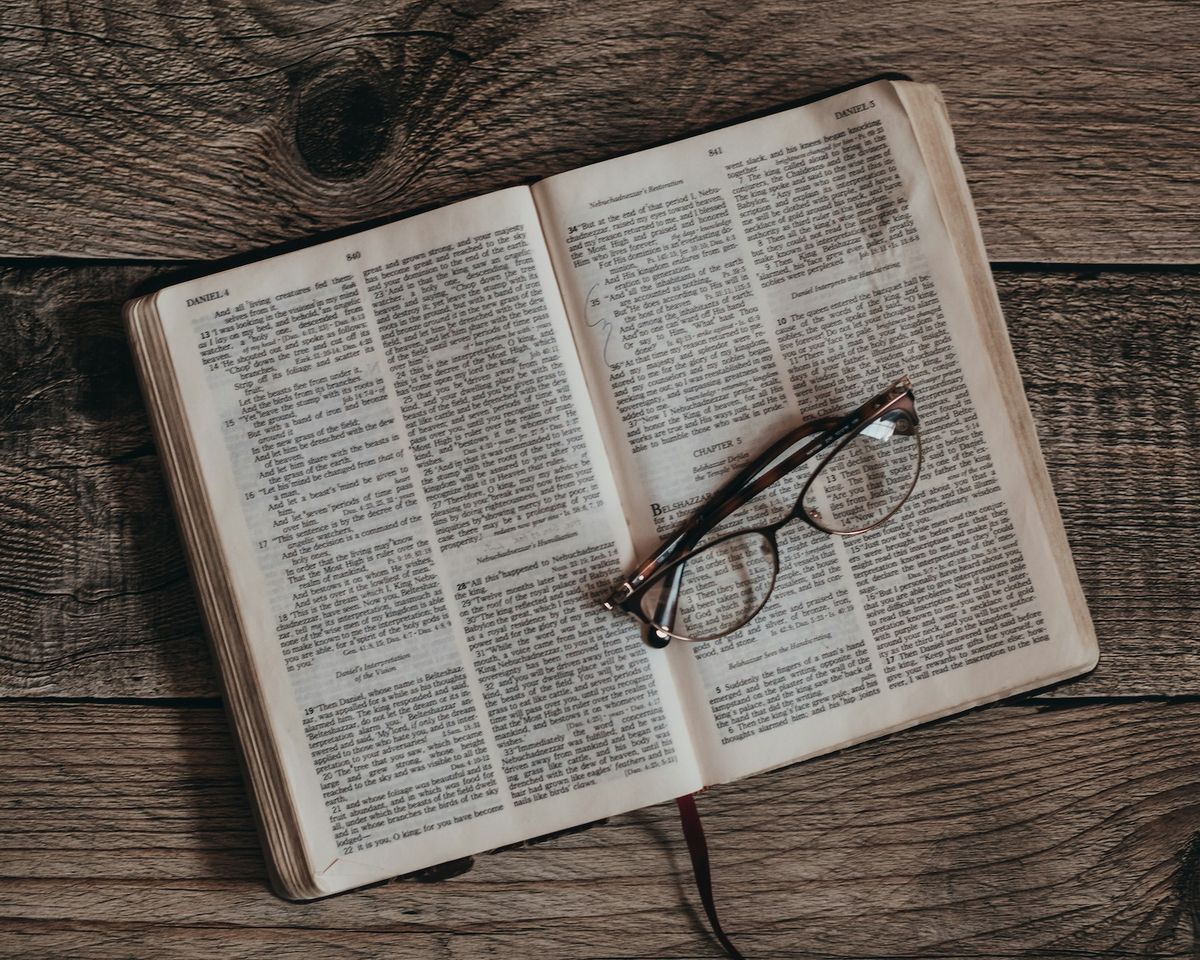 Open Bible with glasses.