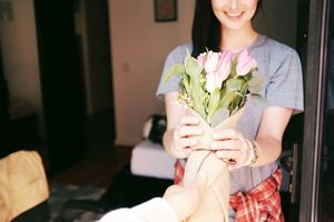Image of a woman receiving flowers as a sign of appreciation