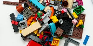 An assortment of legos of many different shapes in a pile.
