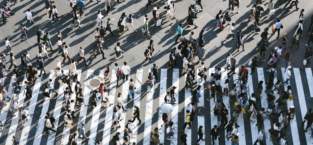 Overhead photo of a busy street filled with pedestrians.