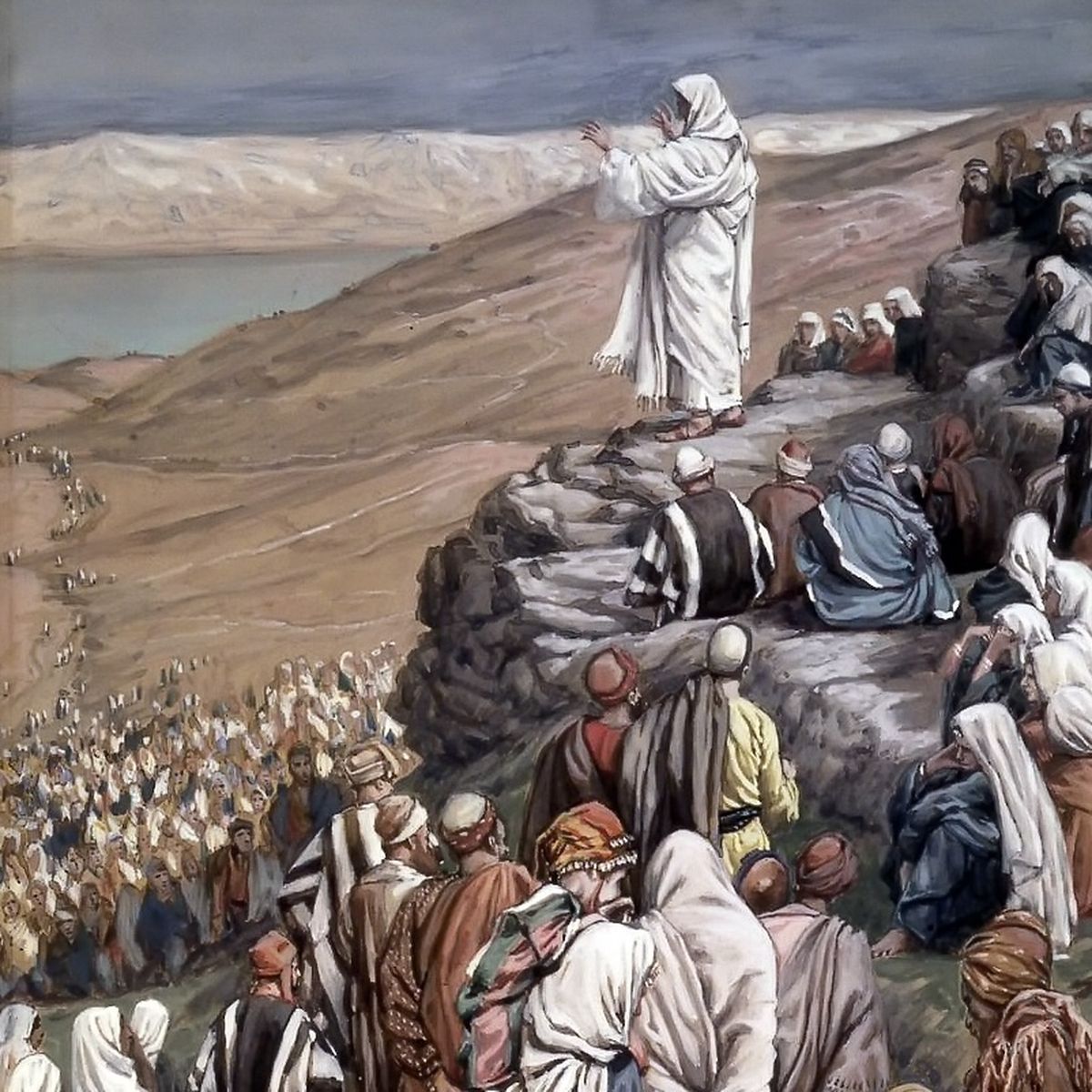 Jesus speaks to a large crowd on a hillside, with a vast landscape and water body in the background.