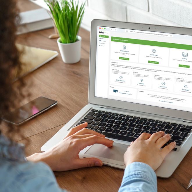 A woman views the Blink Network Host Portal on a laptop
