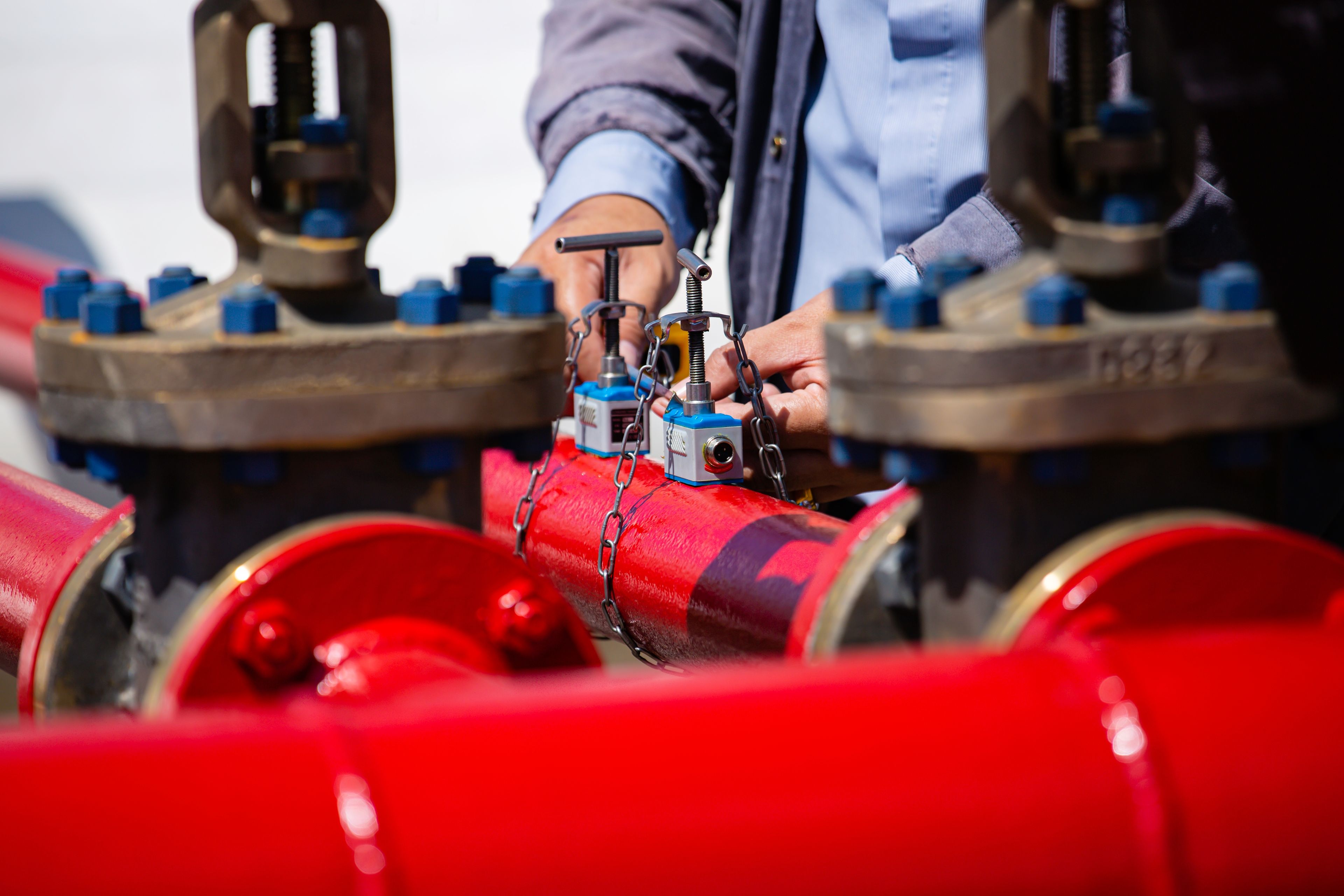 Technician inspecting bolted pipeline components