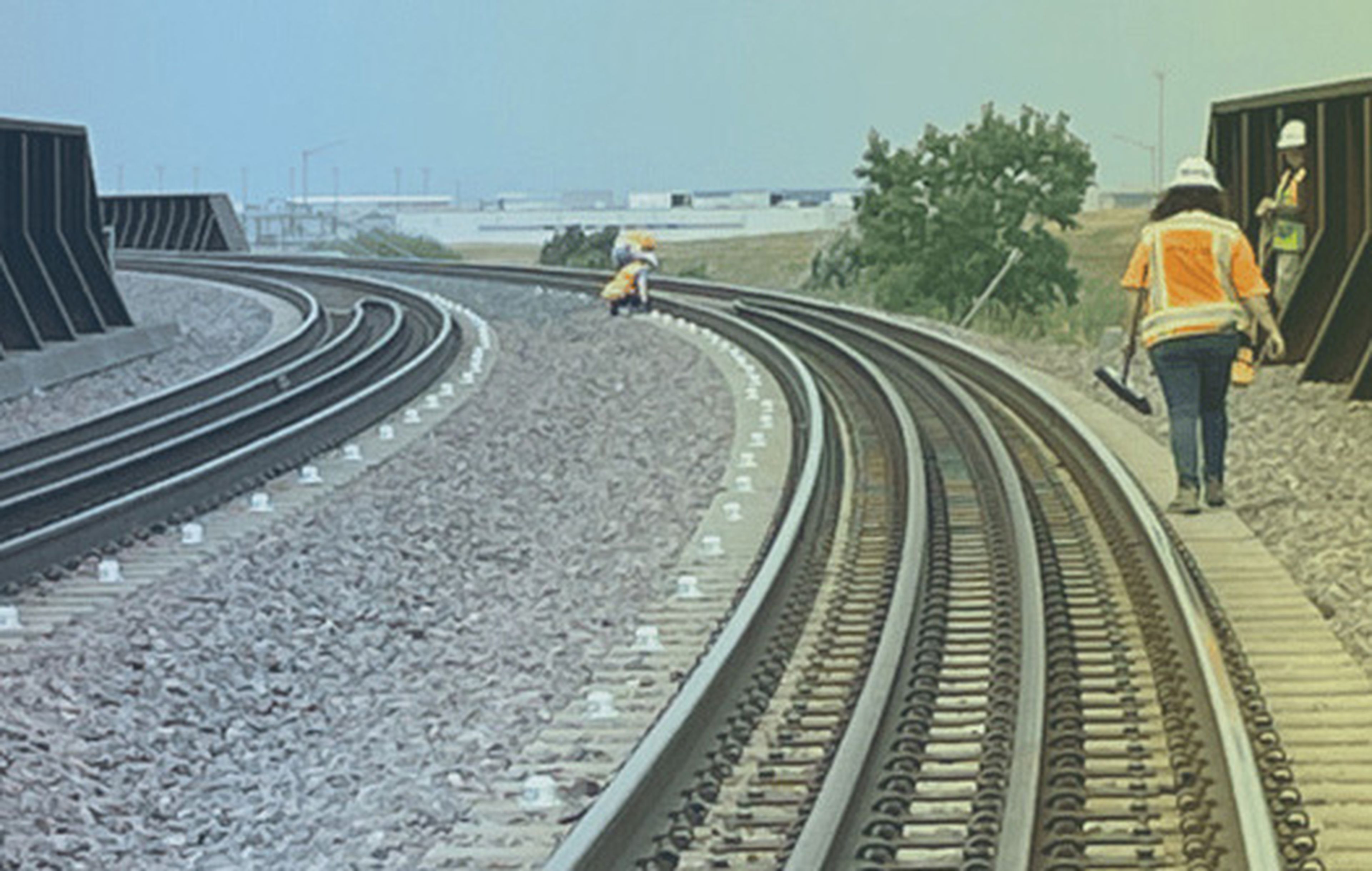 Curving railroad track through a rural landscape