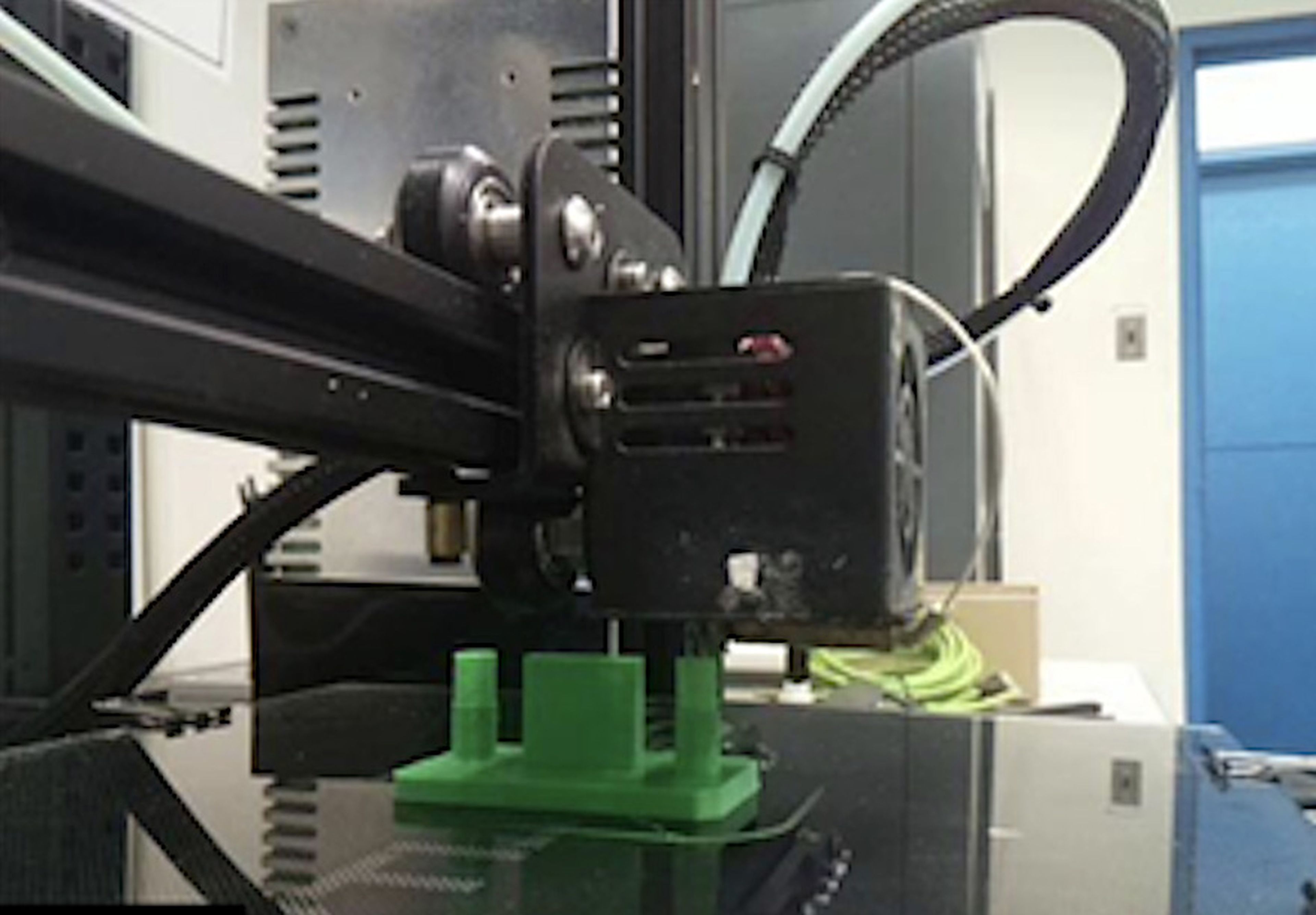 Polymer 3D printer depositing material during additive manufacturing