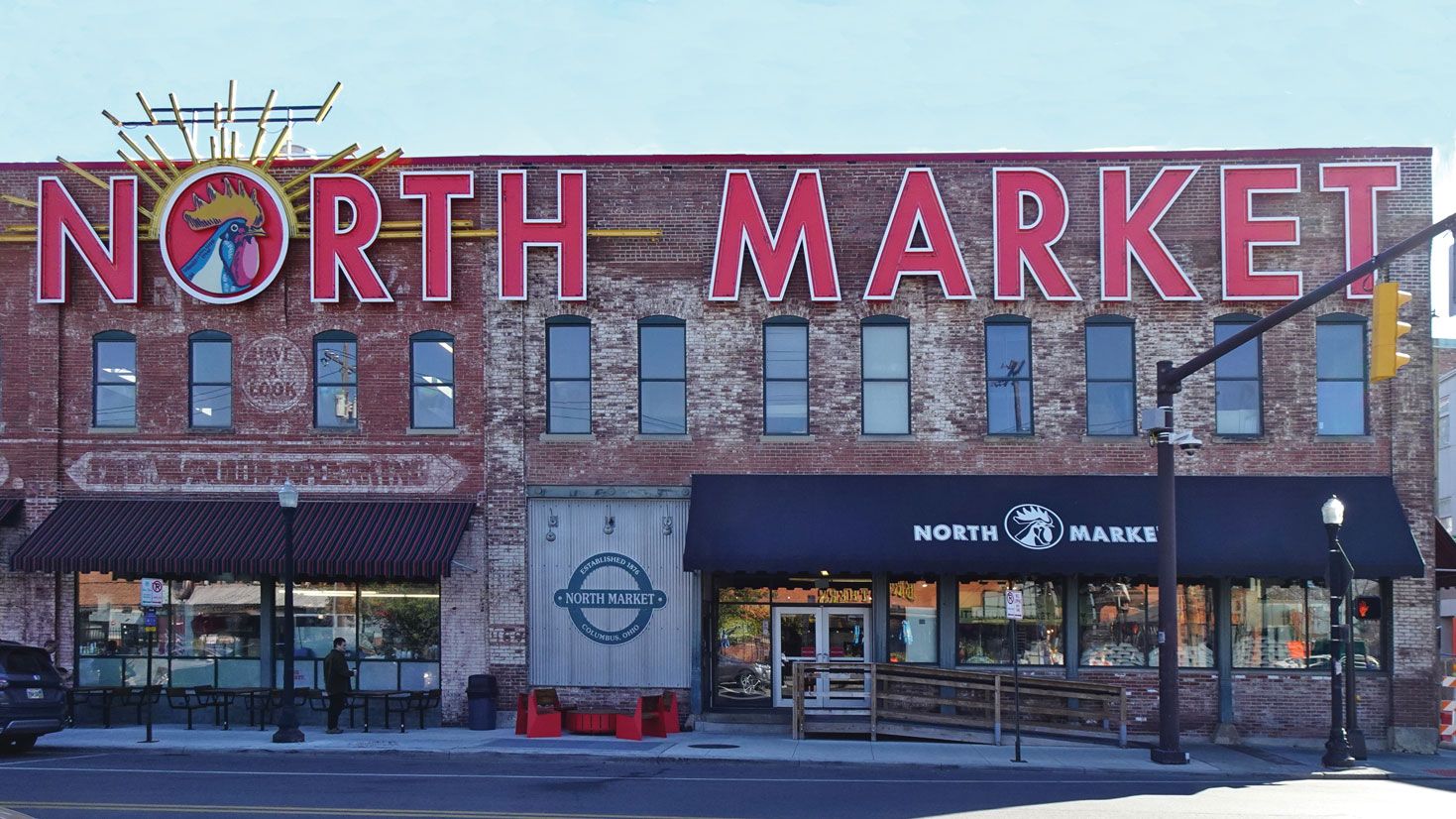Photograph of the exterior of the North Market in Columbus, a brick market hall with a large “North Market” sign, two blocks from the convention center.