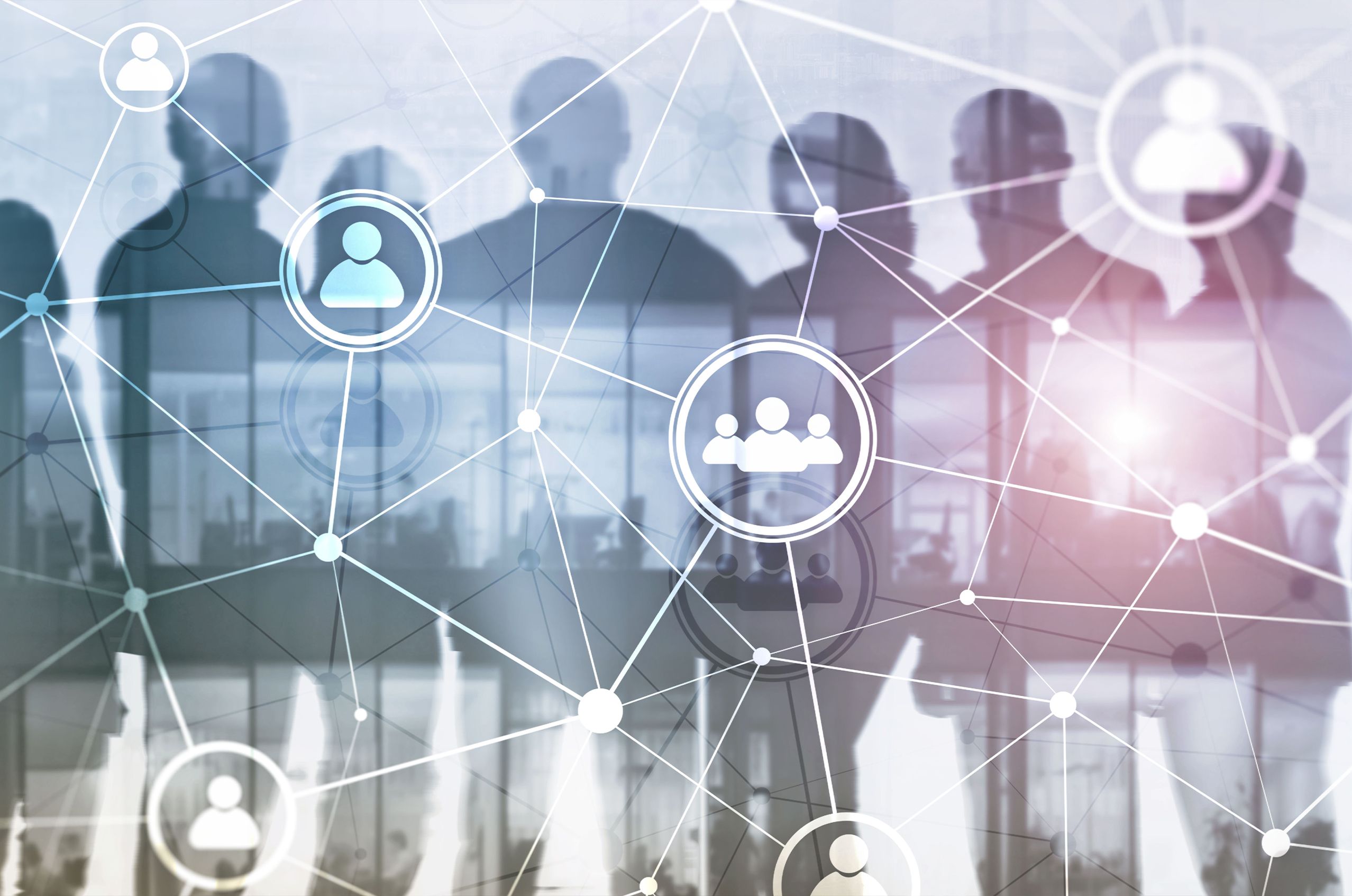 Silhouettes of people behind an abstract network of connected icons, symbolizing connection and networking..