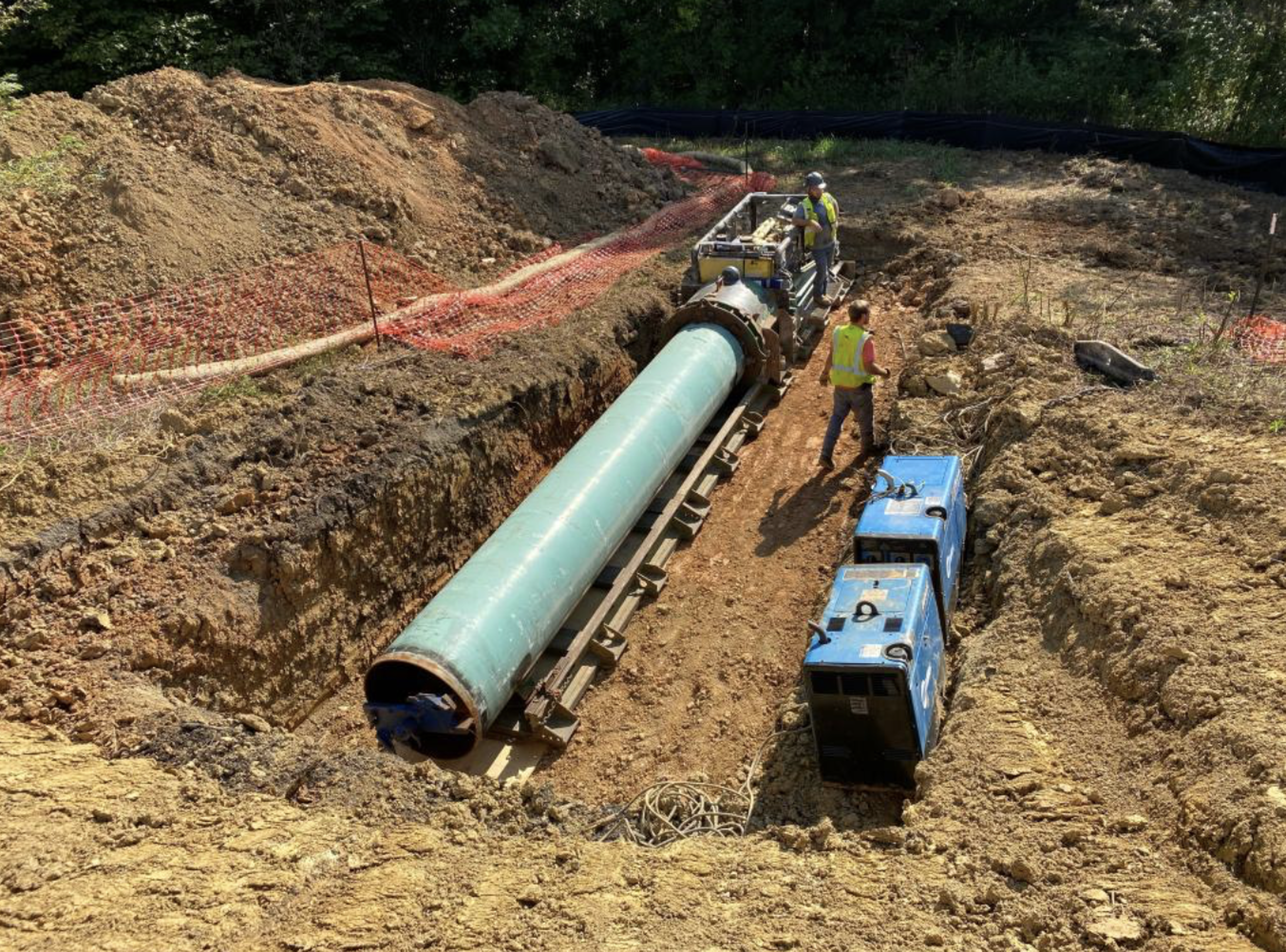 Workers lower a 40 ft steel test tunnel into an excavated trench at ORNL's Oak Ridge campus.