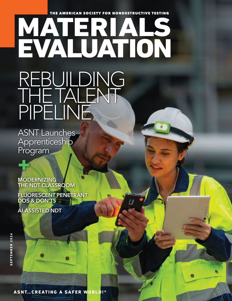 Two construction workers in safety jackets and helmets discuss while looking at a tablet and phone on the cover of "Materials Evaluation" magazine.