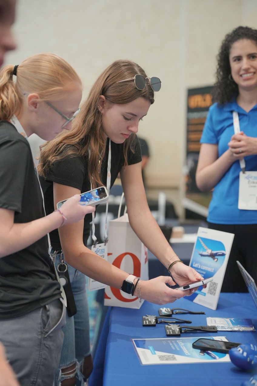 Photograph of the Career Corner at a past ASNT conference: a young attendee examines NDT literature at a booth.