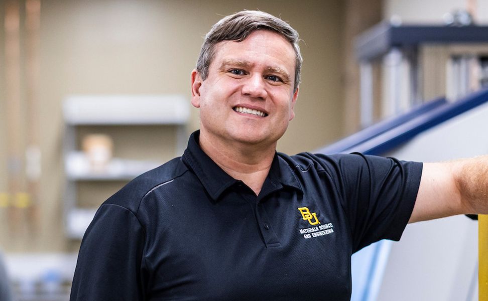 Jack David stands smiling in a workshop setting.
