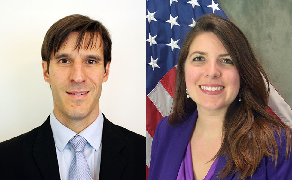 Dr. John Aldring in a suit and tie, and Dr. Christine Knott in a purple blazer, standing in front of a U.S. flag backdrop.