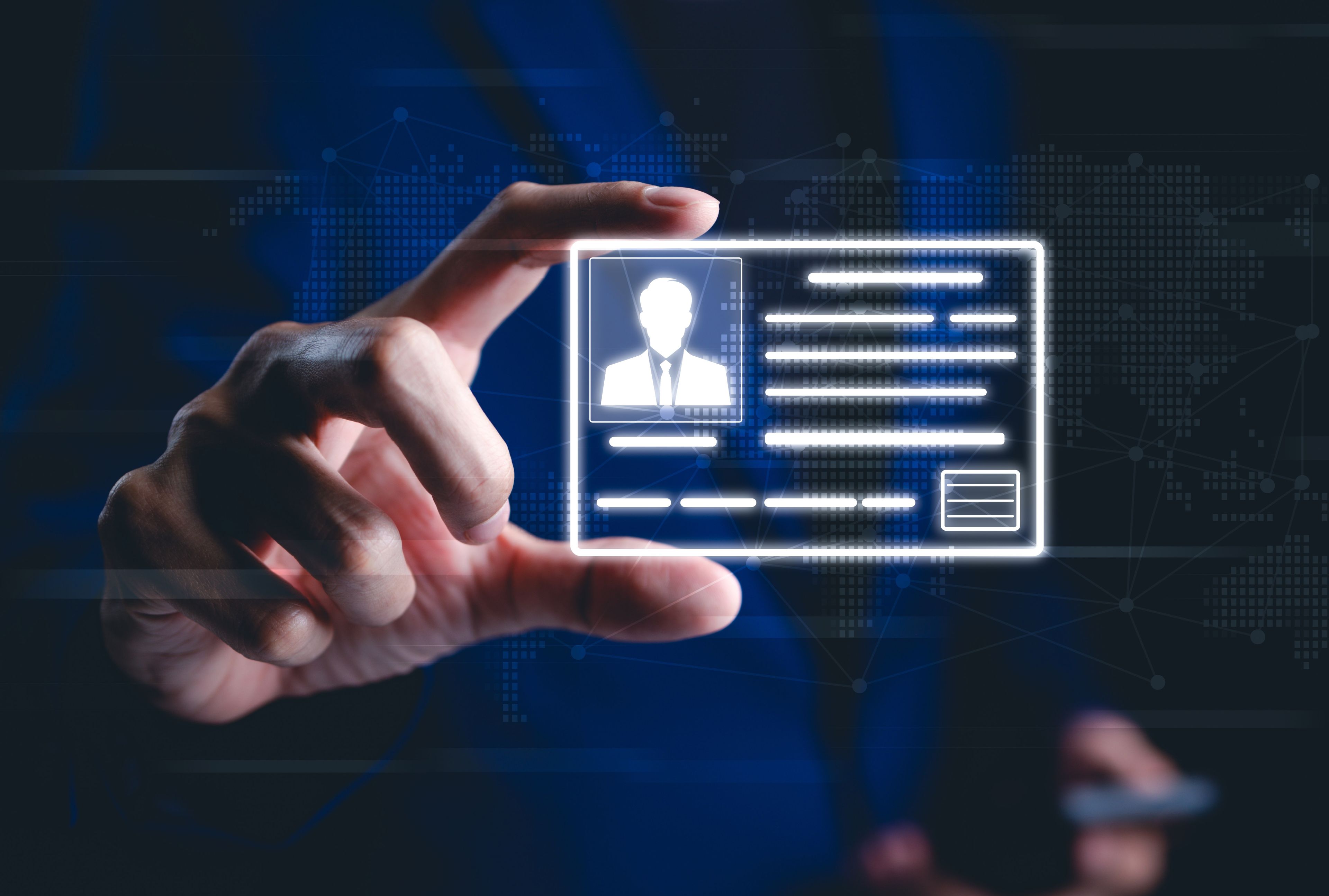 Hand holding a glowing digital ID credential card with profile portrait and data fields, overlaid on a digital world map representing networked verification.