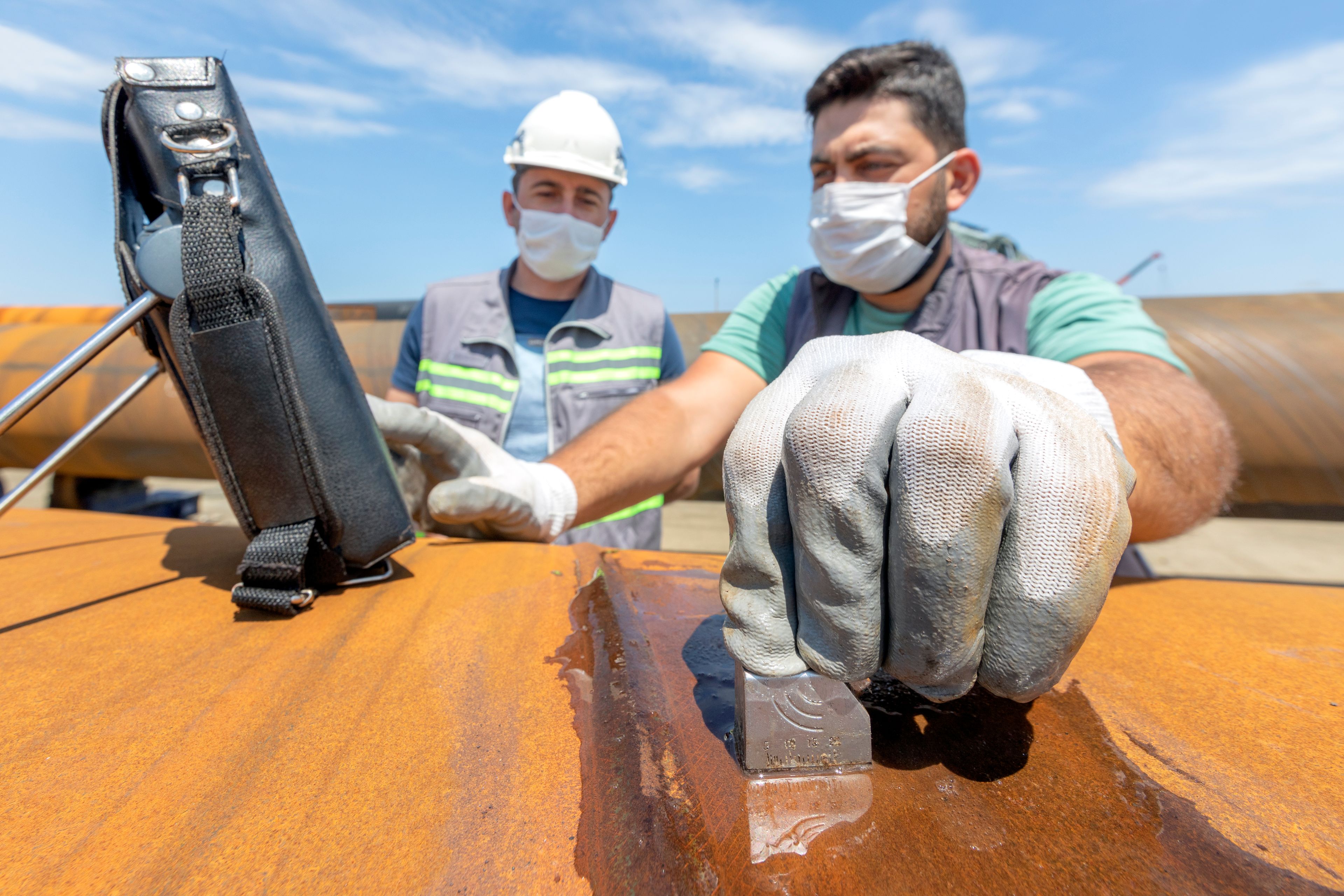 NDT inspectors performing field inspection on a pipeline