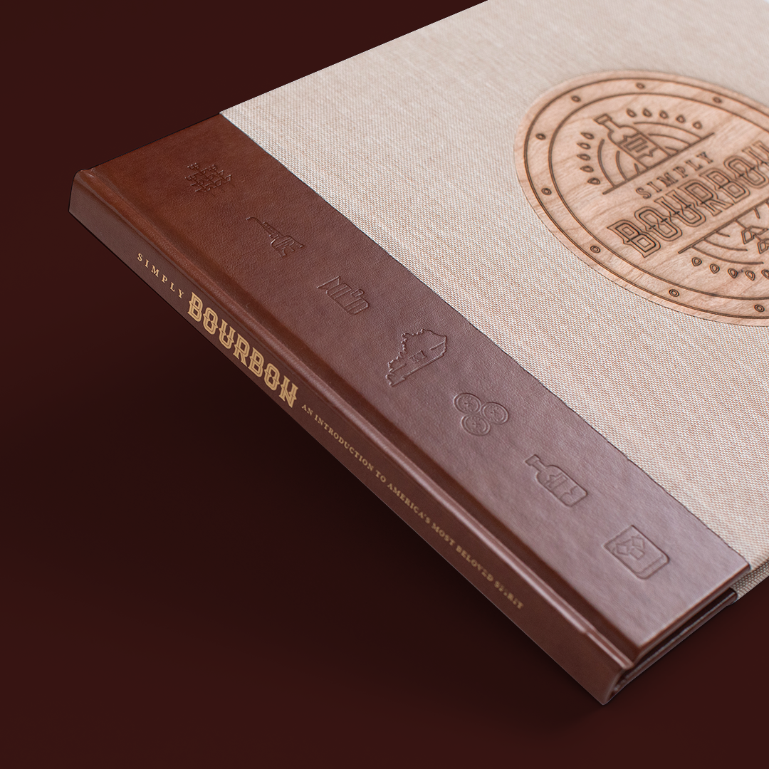 Gold-stamped spine of the hardcover 'Simply Bourbon' book