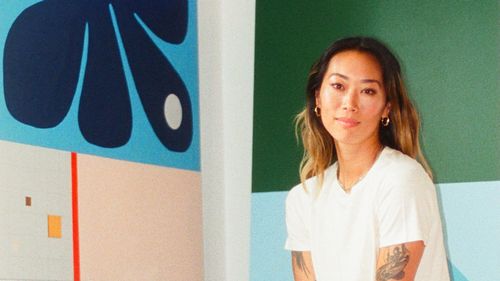 Alyssa Low in her studio surrounded by art