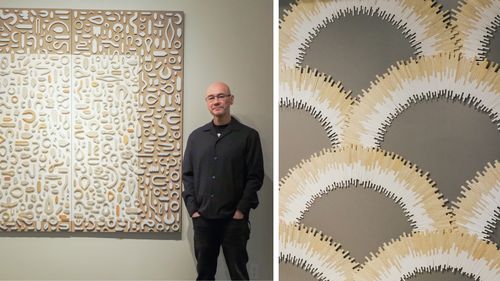 Brian stands beside his art with intricate patterns and textures. Close-up shows overlapping arcs in beige, white, and gray tones.