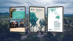 Digital branded reports on tablet with skyline in background of rural African village