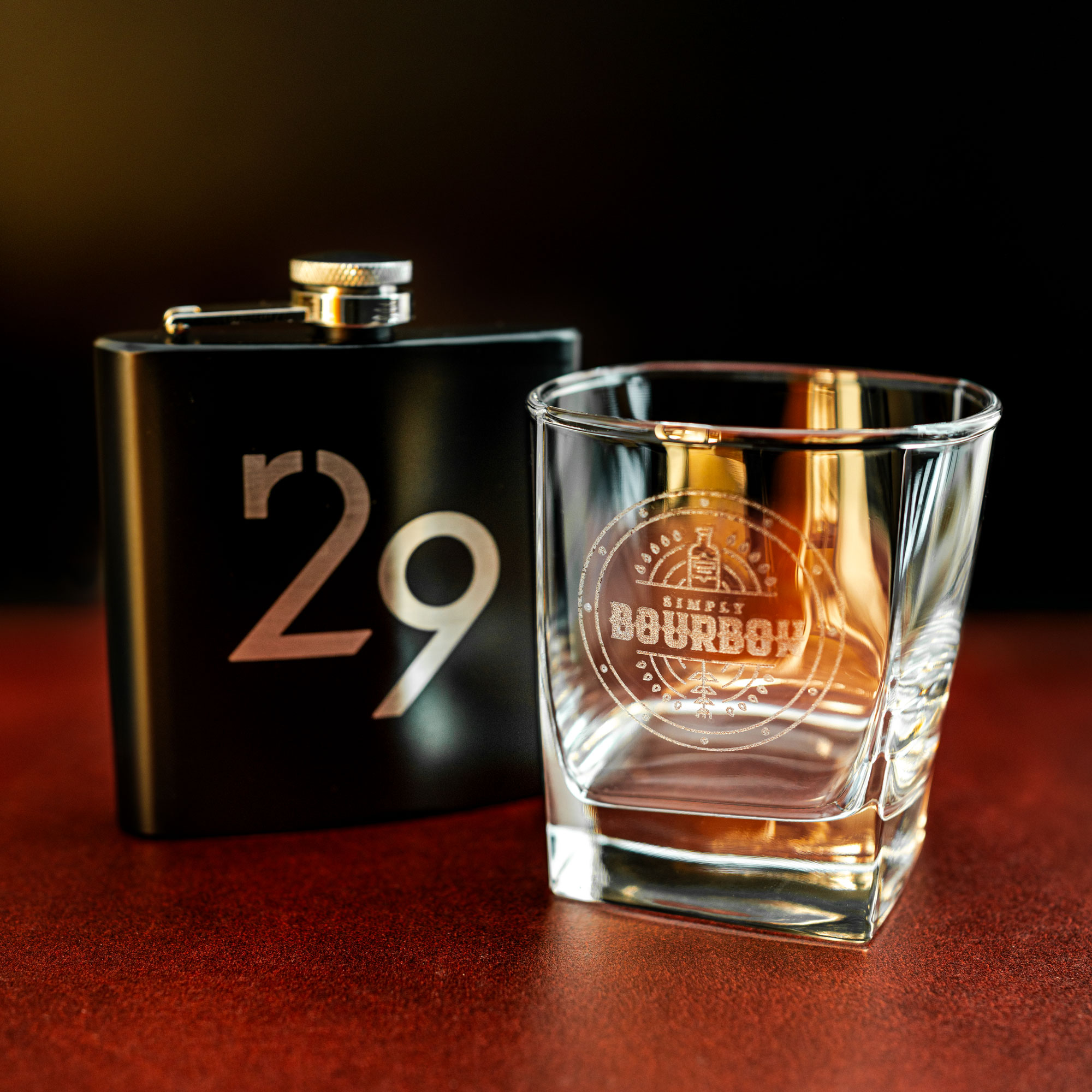 Close up of the R29 flask and Simply Bourbon engraved glass