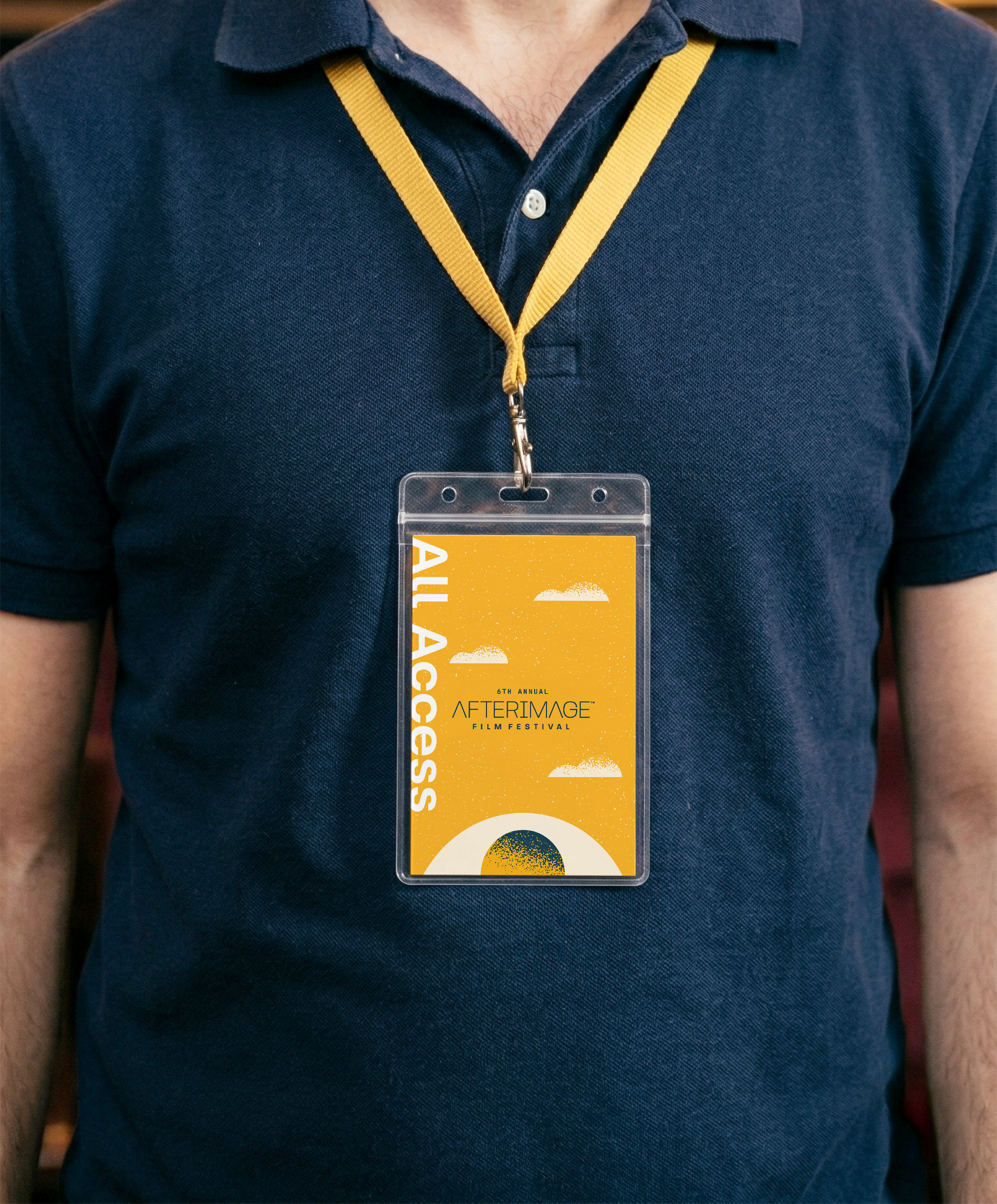 Close up of a man wearing an AfterImage Film Festival badge
