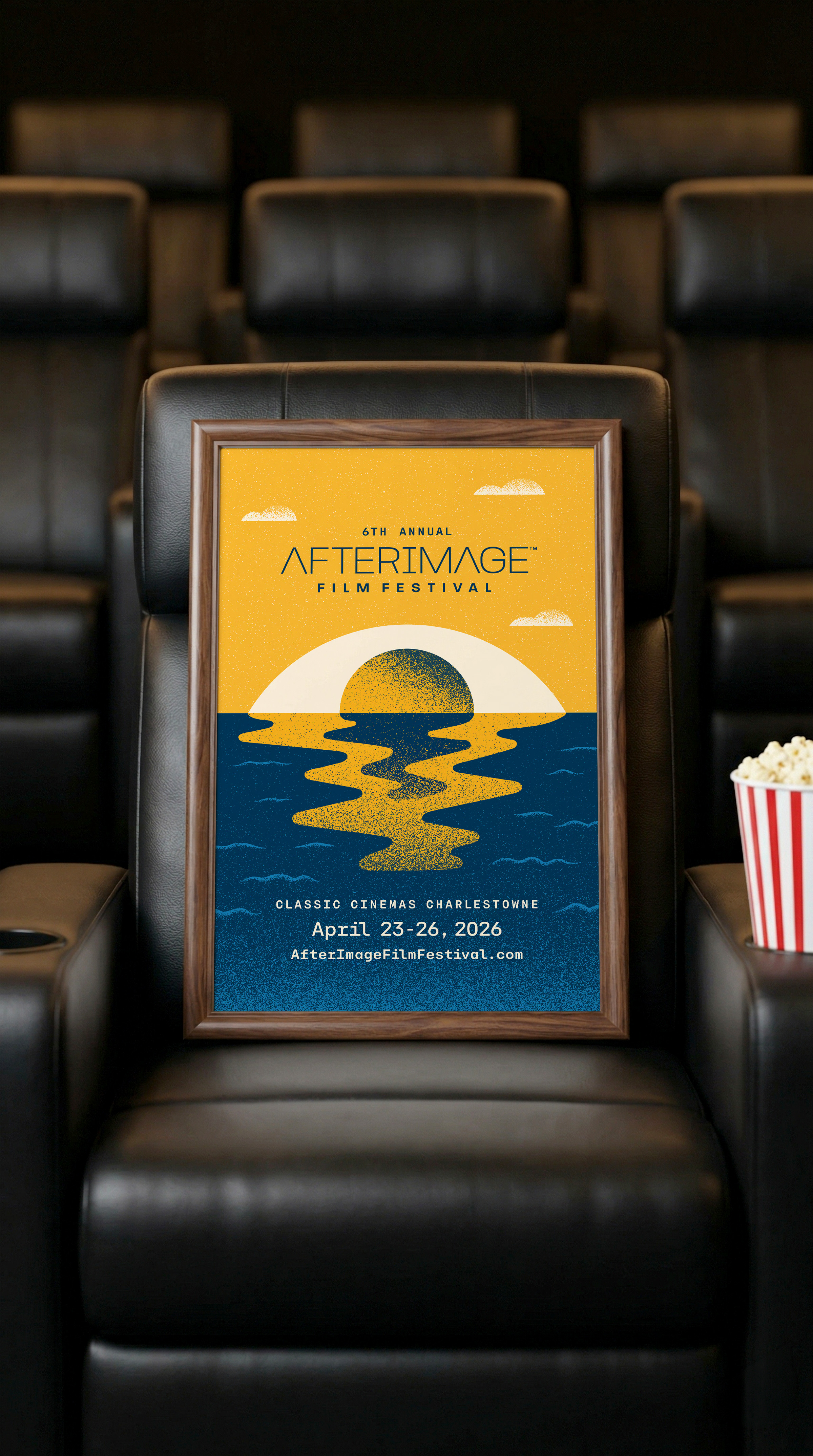 2026 AfterImage Film Festival poster sitting on a theater seat next to a bucket of popcorn