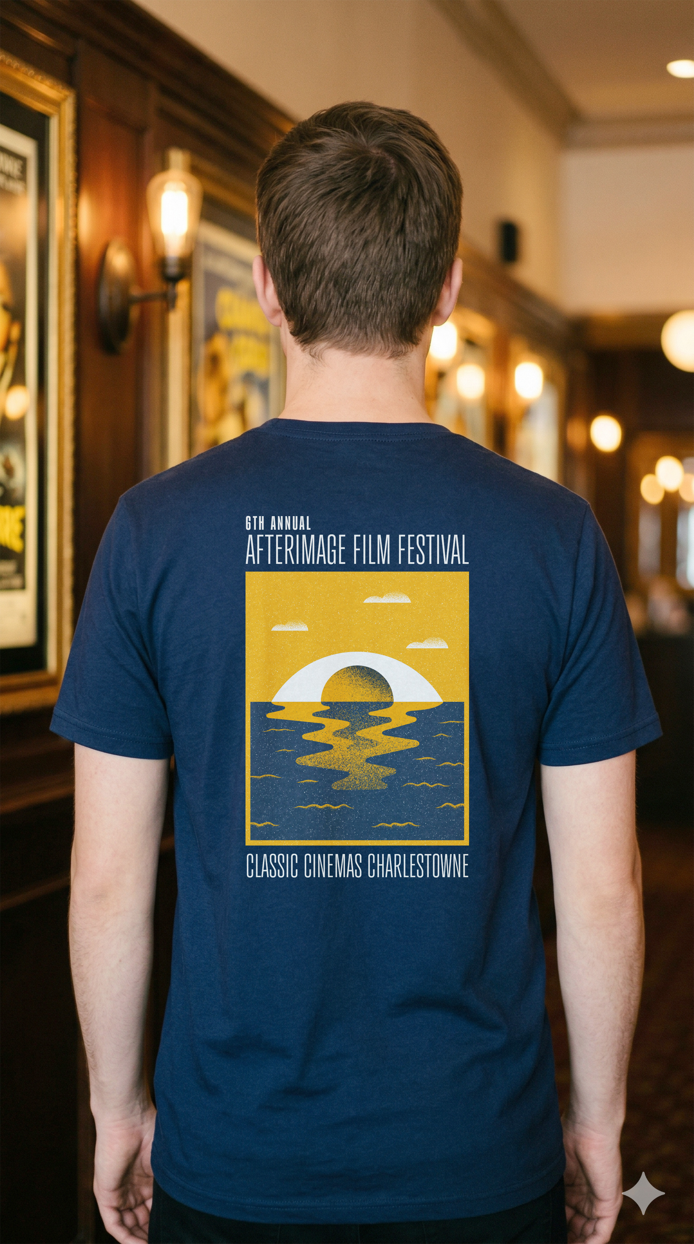 Man wearing a navy t-shirt with the 2026 AfterImage Film Festival art on the back