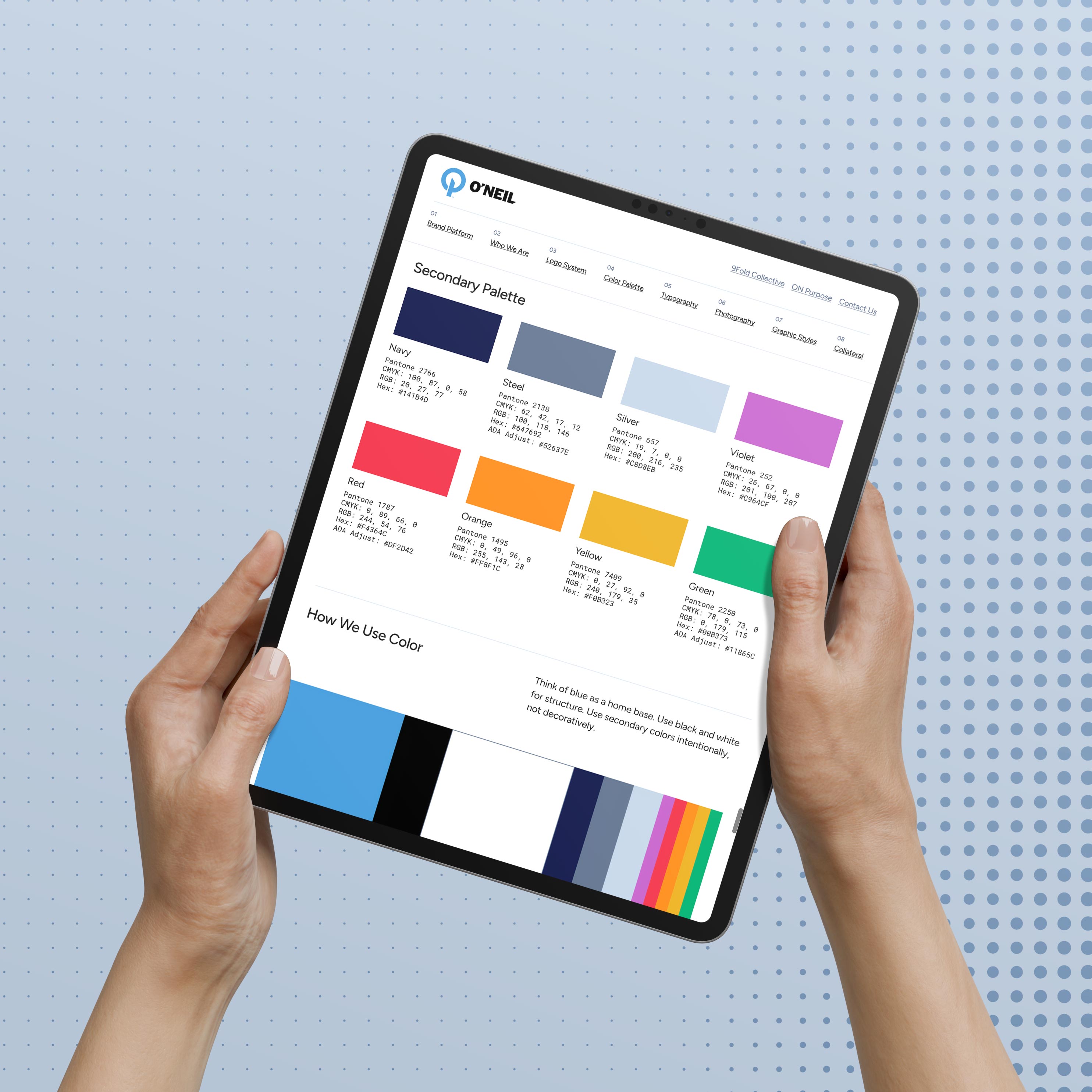 Hands holding a tablet displaying a color palette with multiple swatches labeled by color name and value, on a dotted background.