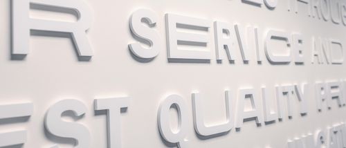 O'Neil interior office wall of white 3D words on a white wall