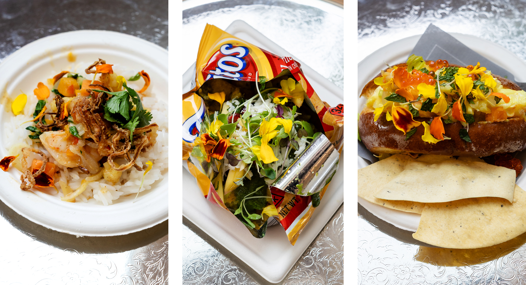 Three dishes: noodles with meat and herbs, a taco in a chips bag with flowers, and a hot dog with toppings and chips on a silver table.