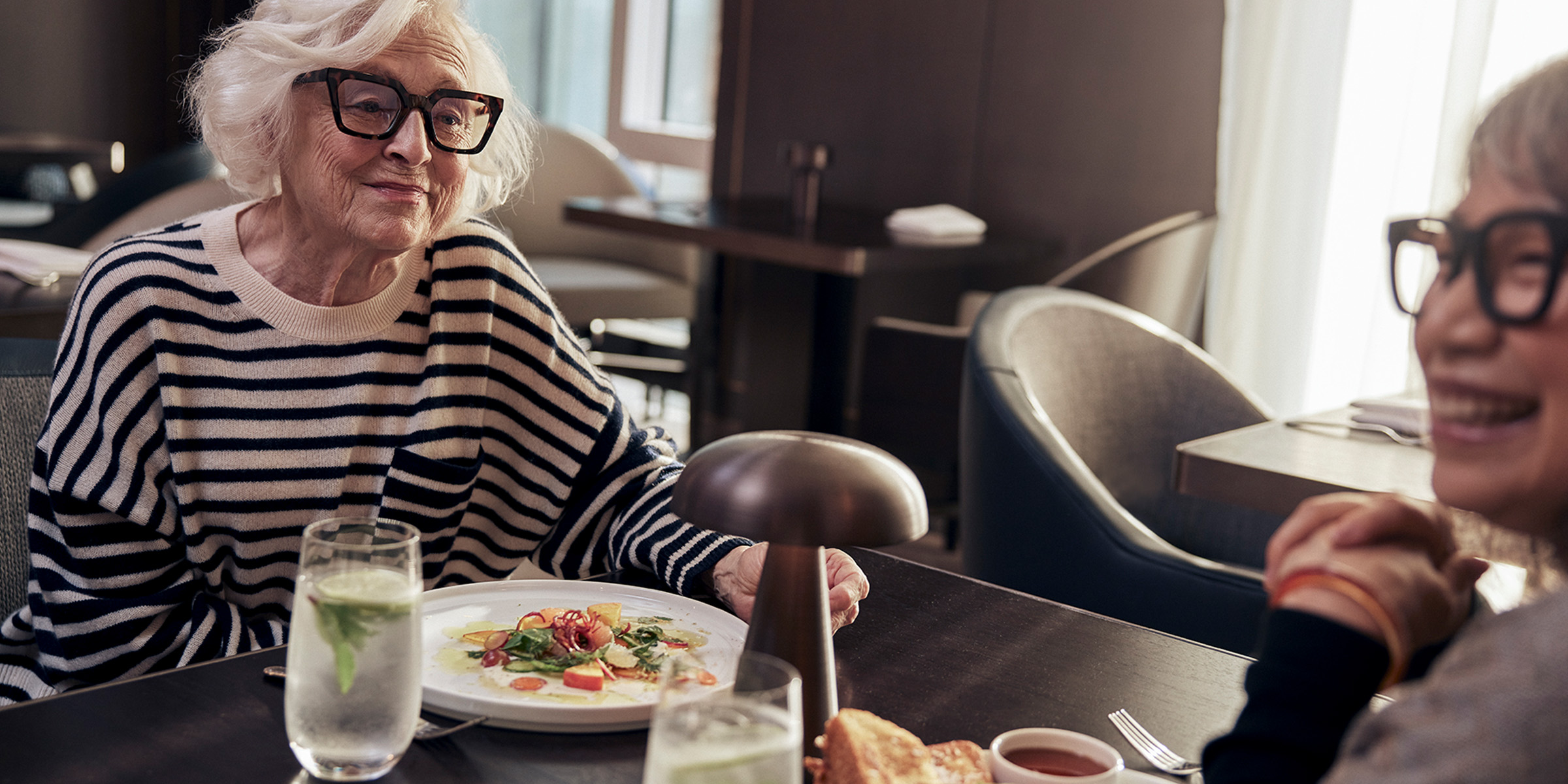 Two Coterie residents eating a meal in the dining room