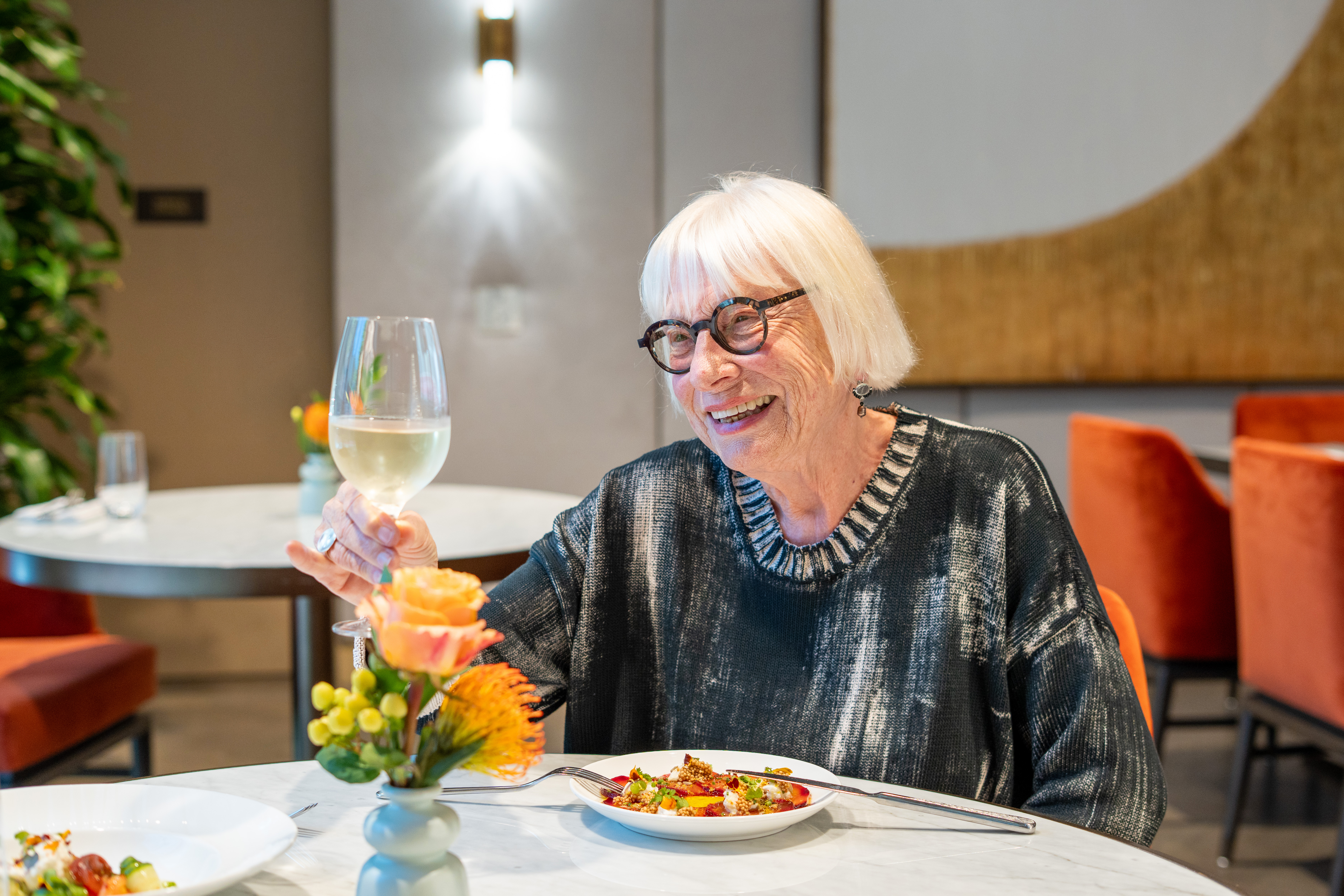 Resident Carol toasts the fine work of Chef Jasmine and the culinary team.