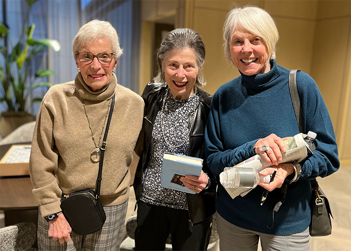 3 Coterie residents at a community event smiling
